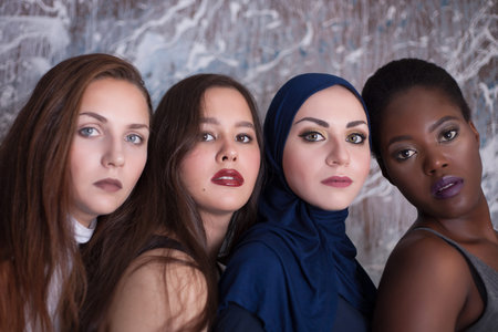 Portrait of four girls with different skin color and nationality in the studioの写真素材