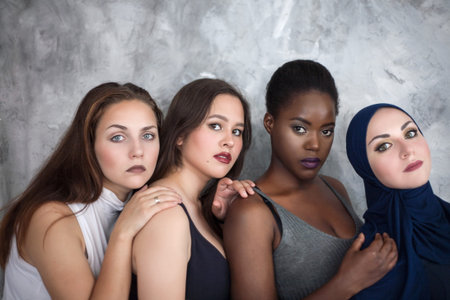 Portrait of four girls with different skin color and nationality in the studio.の写真素材