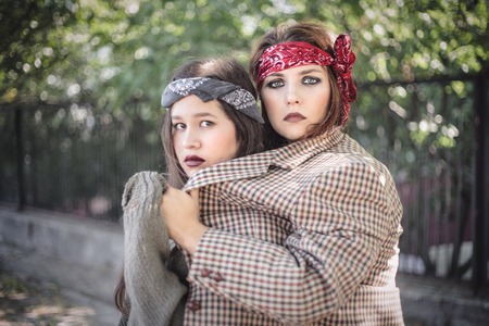 Portrait of two girls outdoors. The concept of difficult teenagers, bad students. Representatives of youth subcultures.の写真素材