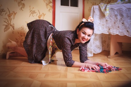 Young beautiful sexy woman washes the floor. Shooting in pinup style, retro.の写真素材