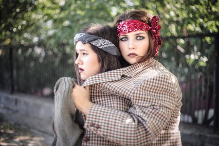 Portrait of two girls outdoors. The concept of difficult teenagers, bad students. Representatives of youth subcultures.の写真素材