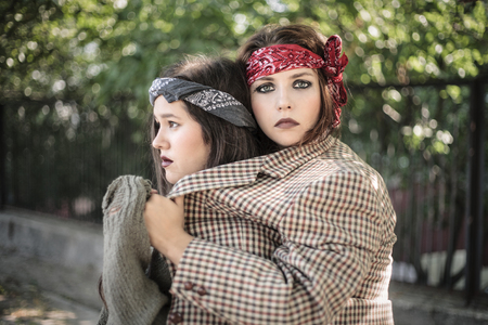 Portrait of two girls outdoors. The concept of difficult teenagers, bad students. Representatives of youth subcultures.の写真素材