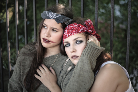 Portrait of two girls outdoors. The concept of difficult teenagers, bad students. Representatives of youth subcultures.の写真素材