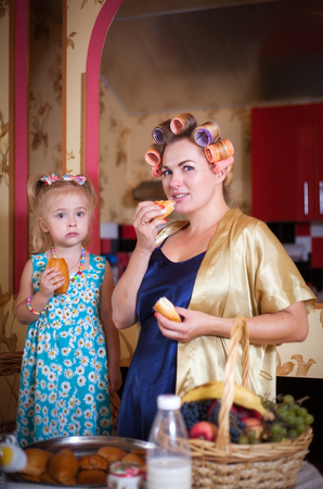 Mom and daughter, portrait in retro style in the vintage interior of the home kitchen.の写真素材
