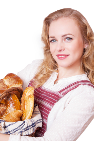 Portrait of cute smiling woman with pastries in her hands in the studio on white backgroundの写真素材