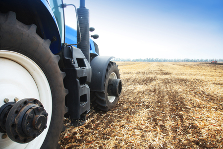 Modern tractor in the field during planting. The concept of agricultural industry. Copy space.の写真素材