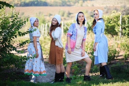 Four women working in her vegetable garden. Vintage rural look.の写真素材
