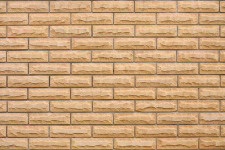 Texture of a yellow brick wall.の写真素材