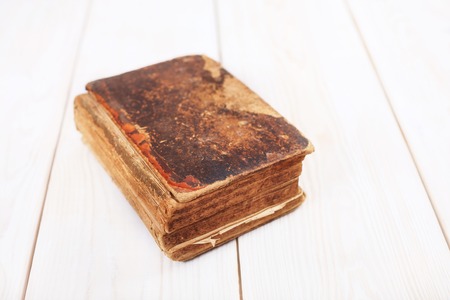 Vintage book with old cover on a white boards background.の写真素材