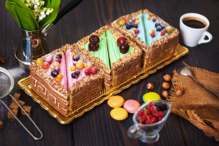 Colored cakes on the table. Coffee and dessert for breakfast. Close-up.の写真素材