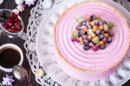Festive cake with pink cream decorated with berries. Homemade baking. Close-up. Top view.の写真素材