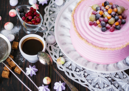 Festive cake with pink cream decorated with berries. Homemade baking. Close-up. Top view.の写真素材