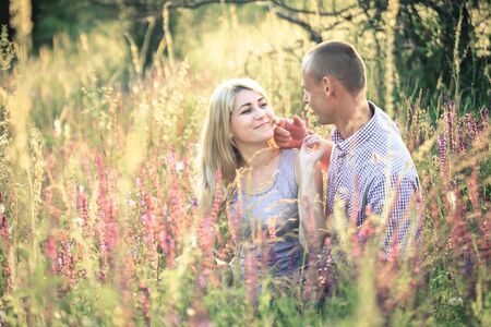 Young couple in love in the summer on the nature outside the city. The concept of relationships, love and relaxation.の写真素材