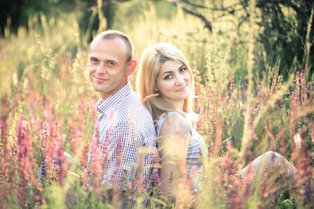 Young couple in love in the summer on the nature outside the city. The concept of relationships, love and relaxation.の写真素材
