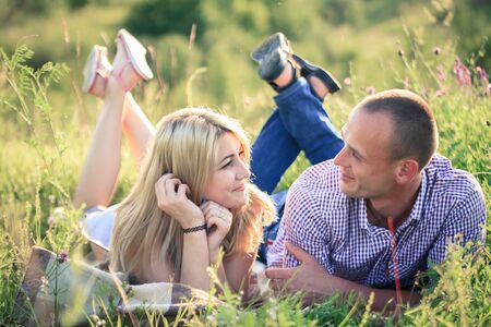 Young couple in love in the summer on the nature outside the city. The concept of relationships, love and relaxation.の写真素材