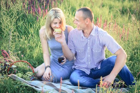 Picnic - Romantic happy couple in meadows nature sunny dayの写真素材