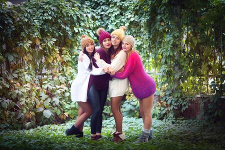 Women best friends smiling and walking at the nature. Outdoors lifestyle fashion portrait. Positive emotions.の写真素材