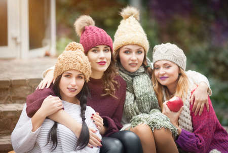 Women are best friends with fruit on a picnic in the countryside. Outdoors lifestyle fashion portrait. Positive emotions.の写真素材