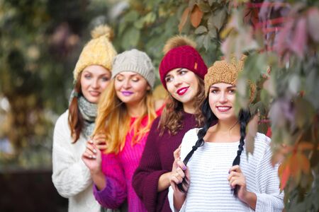 Women best friends smiling and walking at the city. Outdoors lifestyle fashion portrait. Positive emotions.の写真素材