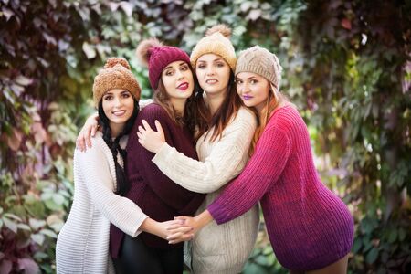 Women best friends hug in autumn park. Outdoors lifestyle portrait. Positive emotions.の写真素材
