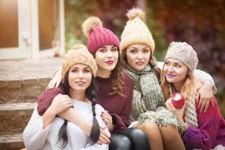 Women are best friends with fruit on a picnic in the countryside. Outdoors lifestyle fashion portrait. Positive emotions.の写真素材