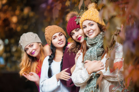 Women best friends smiling and walking at the city. Outdoors lifestyle fashion portrait. Positive...