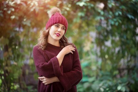 Happy lifestyle portrait of a beautiful young model woman in a warm autumn sweater.の写真素材