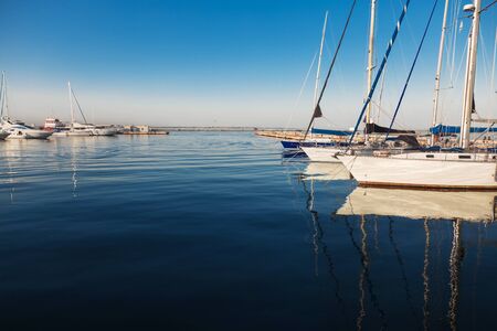Yachts in the seaport on a calm summer day.の写真素材