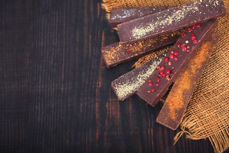 Chocolate with spices on a wooden background close-up.の写真素材