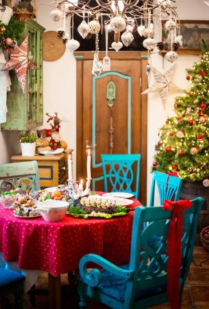 New Year or Christmas interior and festive table with served food.の写真素材