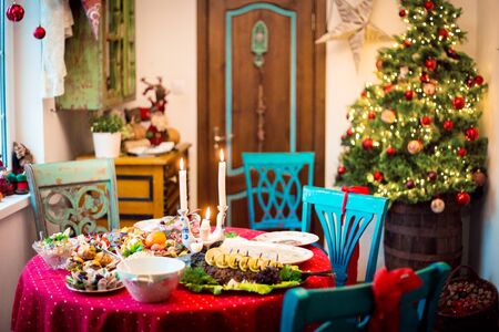 New Year or Christmas interior and festive table with served food.の写真素材