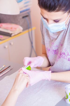 Manicurist does nail care in a beauty salon. Close-up.の写真素材