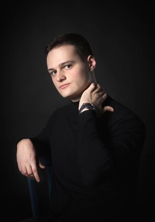 Portrait of an attractive man in the studio on a black background.の写真素材