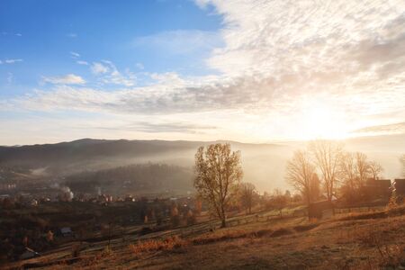 Beautiful picturesque landscape of a mountain village in the fall. Sunset in mountains.の写真素材