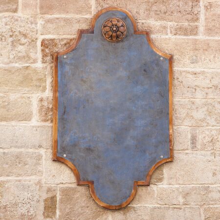 Blank plate, poster, sign on the wall. Close-up outdoors.の写真素材