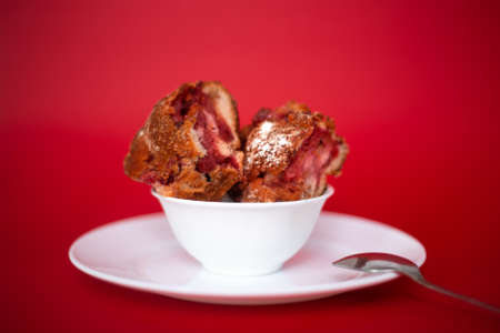 Piece of cherry homemade pie on a red background. Baking, studio photography.の写真素材