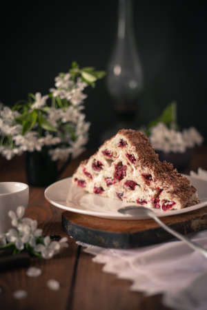 Homemade cake with cherries and cream on a wooden table. Dessert close-up.の写真素材