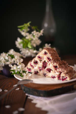 Homemade cake with cherries and cream on a wooden table. Dessert close-up.の写真素材