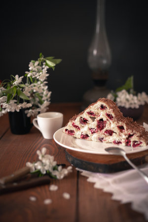 Homemade cake with cherries and cream on a wooden table.の写真素材