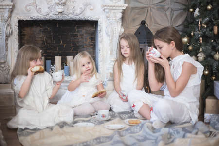 Girls sisters in winter morning drink tea winter christmas new year.の写真素材
