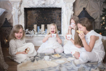 Girls sisters in winter morning drink tea winter christmas new year.の写真素材