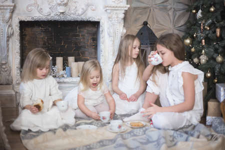 Girls sisters in winter morning drink tea winter christmas new year.の写真素材