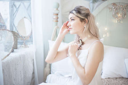 Cute beautiful woman in the morning in bed, vintage style. High quality photoの写真素材