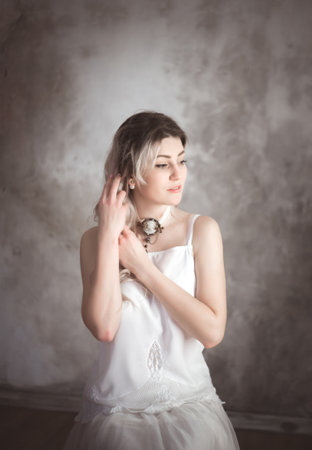 Portrait of a young beautiful woman in vintage style in the studio.の写真素材