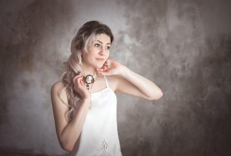 Portrait of a young beautiful woman in vintage style in the studio.の写真素材
