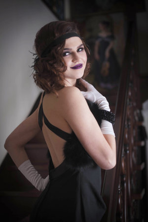 Portrait of a woman in a retro style in a vintage interior.の写真素材
