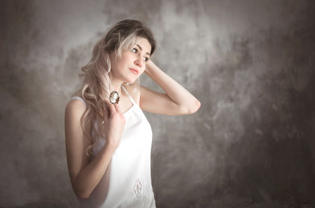 Portrait of a young beautiful woman in vintage style in the studio.の写真素材