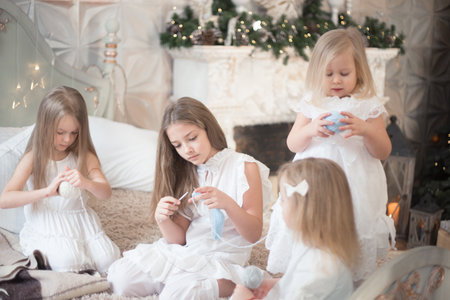Little girls sisters or friends are doing needlework in the bedroom. Retro style.の写真素材