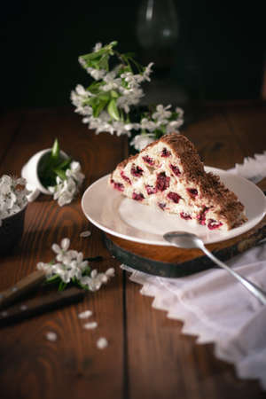 Homemade cake with cherries and cream on a wooden table. Dessert close-up.の写真素材