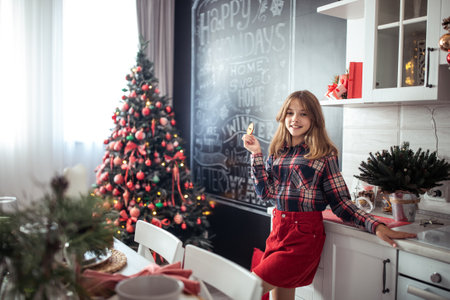 Cute teenage girl in a room with a decorated Christmas tree. The winter holidays. high quality photoの写真素材